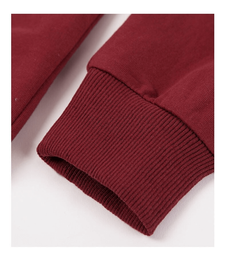 Close-up of a burgundy long sleeve cuff from a women's sweatshirt, featuring a ribbed texture for a comfortable fit.